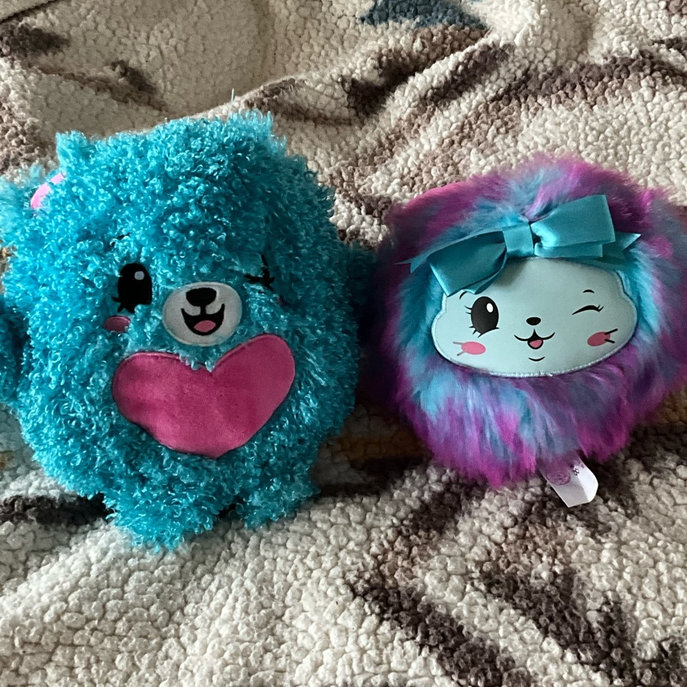 Two pom pom stuffed animals